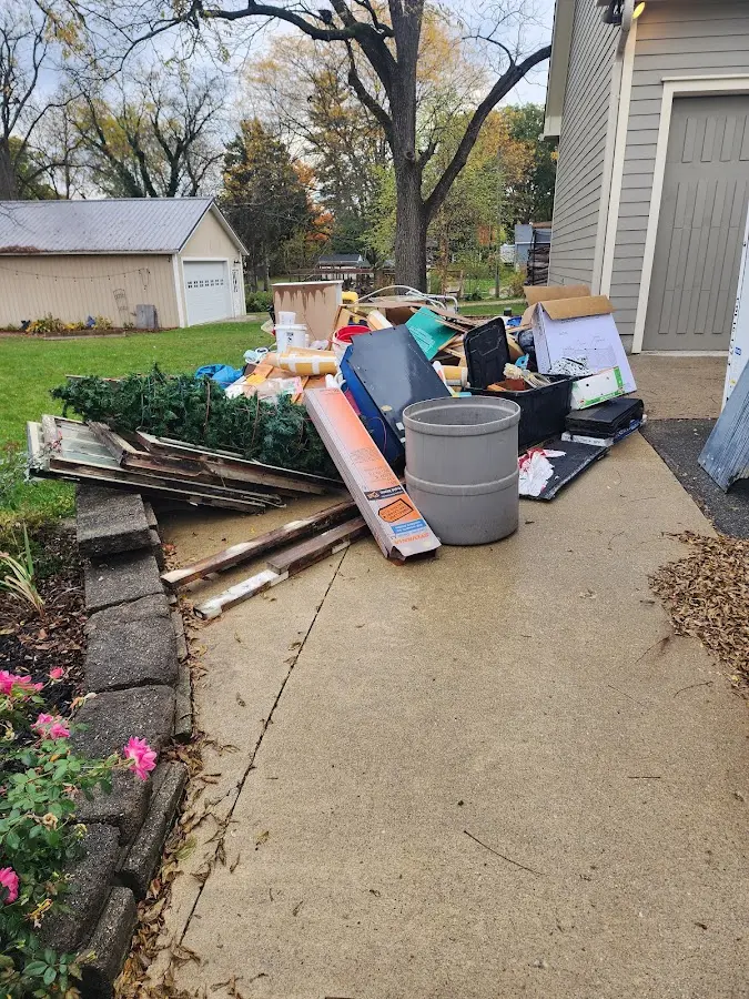 Dumpster being loaded with debris for Commercial Dumpster Rental in Sioux City